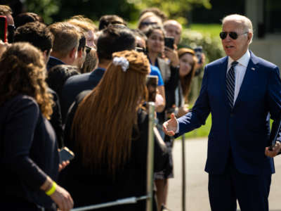 President Joe Biden greets guests after disembarking from Marine One, returning to the White House from Rehoboth, Delaware, on the South Lawn of the White House on August 24, 2022, in Washington, D.C.