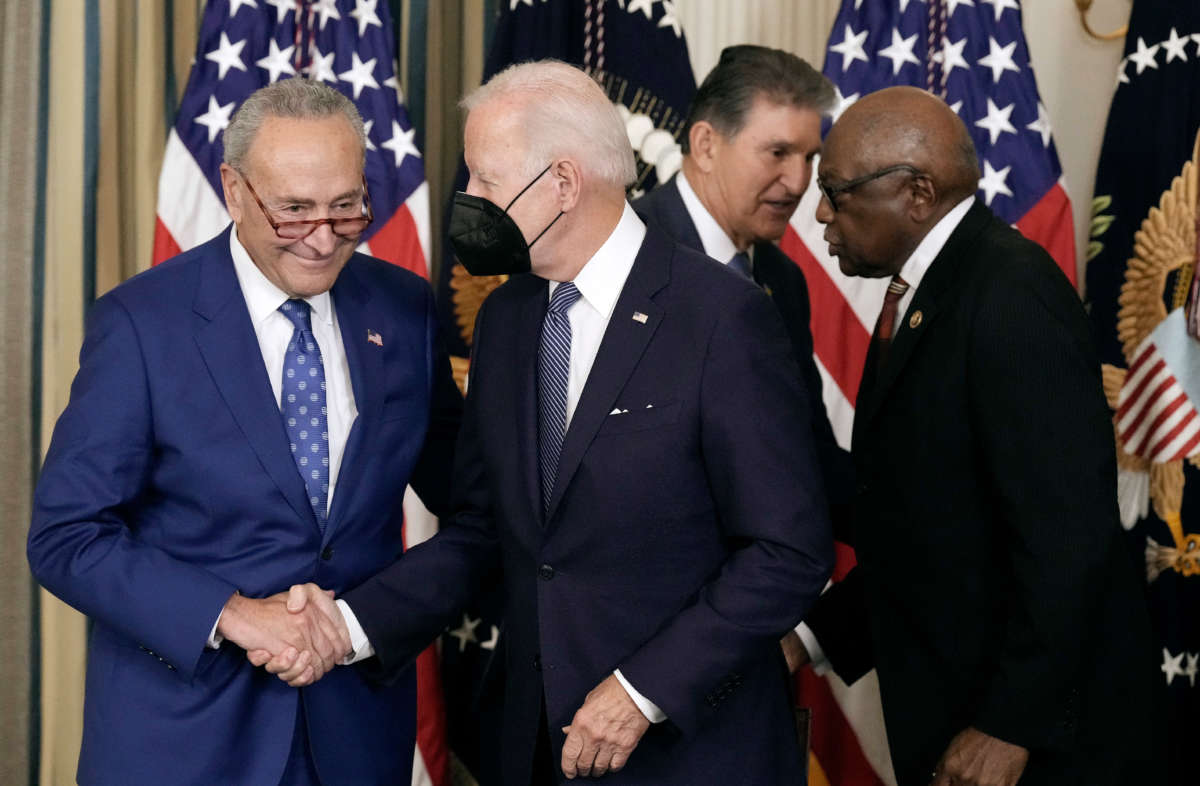 Senate Majority Leader Charles Schumer, left, shakes hands with President Joe Biden after he signed The Inflation Reduction Act in the State Dining Room of the White House on August 16, 2022, in Washington, D.C.