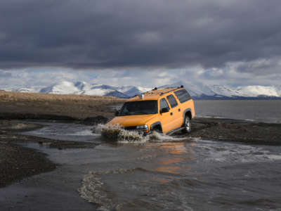A vehicle drives beside the melting permafrost tundra on the edge of the Bering Sea at the town of Quinhagak on the Yukon Delta in Alaska on April 12, 2019.