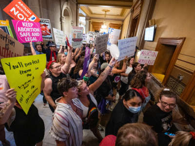 Abortion rights protesters chant during a session of the Indiana State Senate on July 25, 2022, in Indianapolis, Indiana.