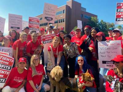 Rep. Ilhan Omar poses with nurses on the picket line in Minneapolis, Minnesota on September 12, 2022.