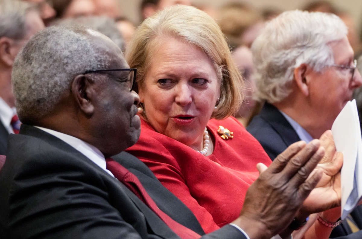Associate Supreme Court Justice Clarence Thomas sits with his wife and conservative activist Virginia 'Ginni' Thomas while he waits to speak at the Heritage Foundation on October 21, 2021, in Washington, D.C.