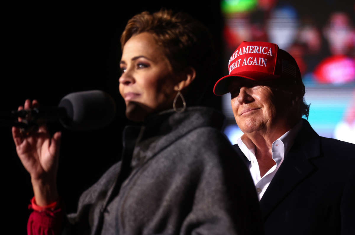 Republican governor candidate for Arizona Kari Lake, left, speaks as former President Donald Trump looks on at a rally at the Canyon Moon Ranch festival grounds on January 15, 2022, in Florence, Arizona.