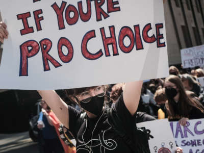 A pro-choice protester holds a placard in support of Roe v. Wade in Detroit, Michigan, on May 7, 2022.