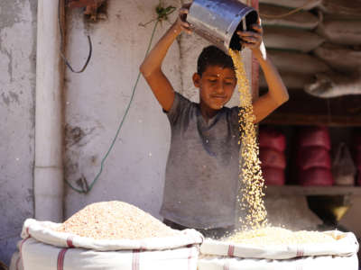 A seller and sacks of legumes are seen at a market area in Taiz, Yemen, on March 10, 2022.