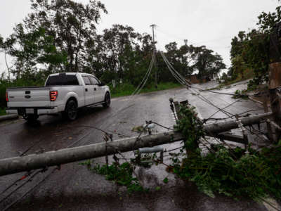 Downed power lines are seen on the road in San Juan, Puerto Rico, as the island awoke to a general power outage on September 19, 2022.