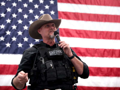 Pinal County Sheriff Mark Lamb speaks with attendees at an event for mayoral candidate Jason Beck at TYR Tactical in Peoria, Arizona, in March, 2022.