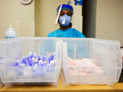Nurse prepares PCR COVID-19 testing kits