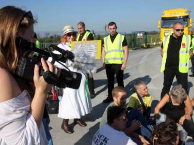 Protesters sit at the entrance of a fracking site in Lancashire to prevent work from progressing.