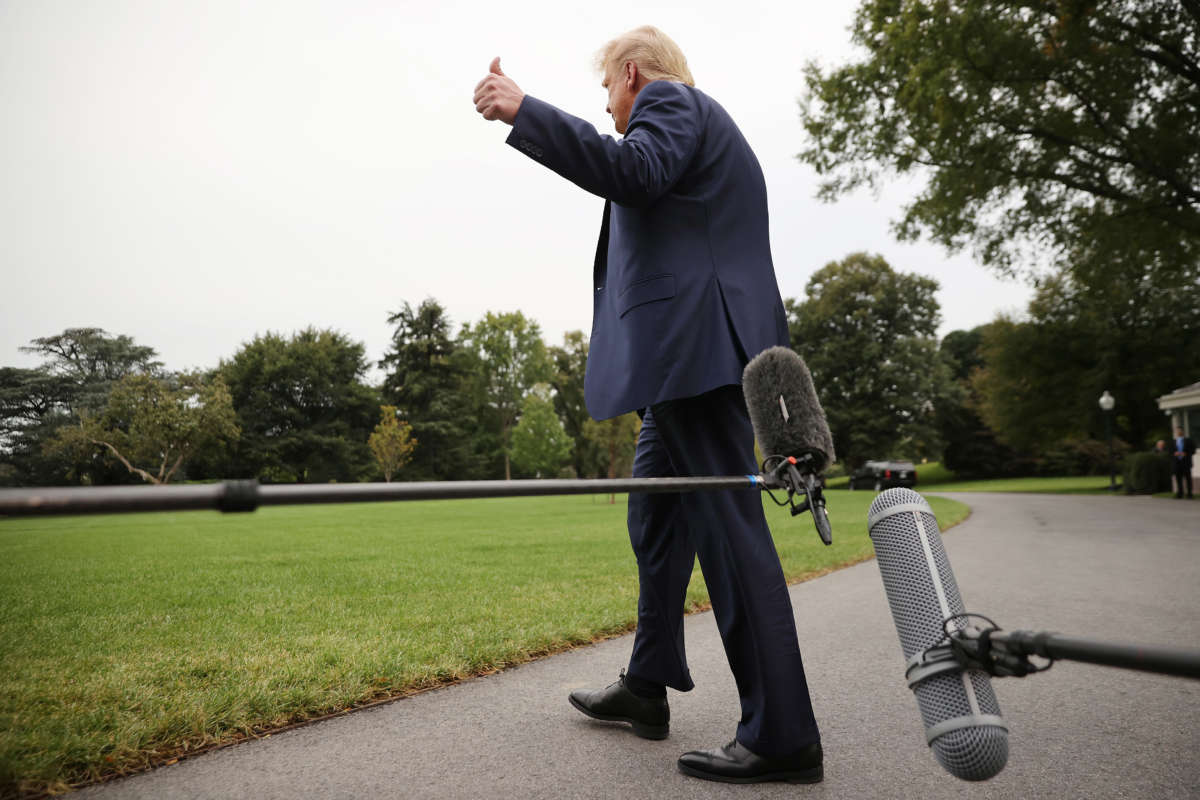Then-President Donald Trump gestures after talking to journalists before departing the White House on September 24, 2020, in Washington, D.C.