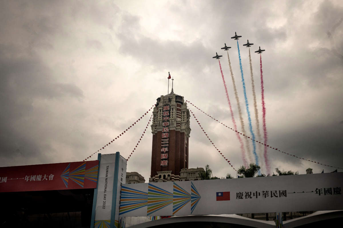 Trainer jets from the Republic of China Air Force fly over Taipei's Presidential Office Building while letting out colored smoke of Taiwan's flag.