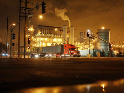 A truck drives past a power plant