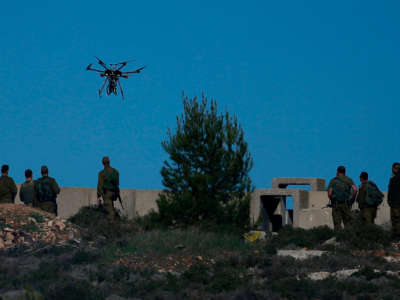 Israeli soldiers look at a drone prepared to throw gas canisters during clashes with Palestinian protestors in Ramallah, near the Jewish settlement of Beit El, in the occupied West Bank on December 14, 2018.