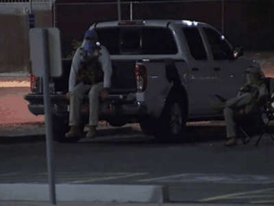 Armed vigilantes dressed in tactical gear watch a drop box site in this photograph disseminated by the Maricopa County Elections Department.