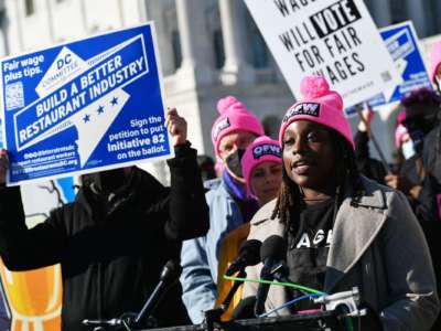 Restaurant worker Ifeoma Ezumaki speaks during a rally to call for restaurant workers to be paid a full minimum wage with tips at the House Triangle of the U.S. Capitol in Washington, D.C. on February 8, 2022.