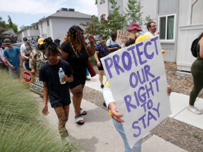 Tenants and activists march after a rally at the Delta Pines apartment complex in Antioch, California, on June 22, 2022.