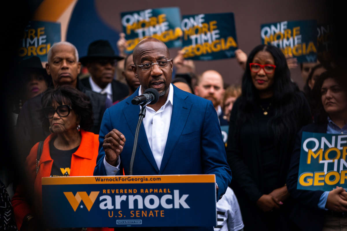 Sen. Raphael Warnock delivers remarks to supporters and attendees at the John Lewis Mural in Atlanta, Georgia, on November 10, 2022.