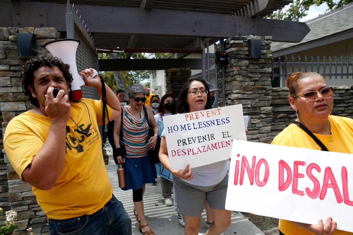 Betty Gabaldo, center, marches with tenants and activists after a rally at the Delta Pines apartment complex in Antioch, California, on June 22, 2022.