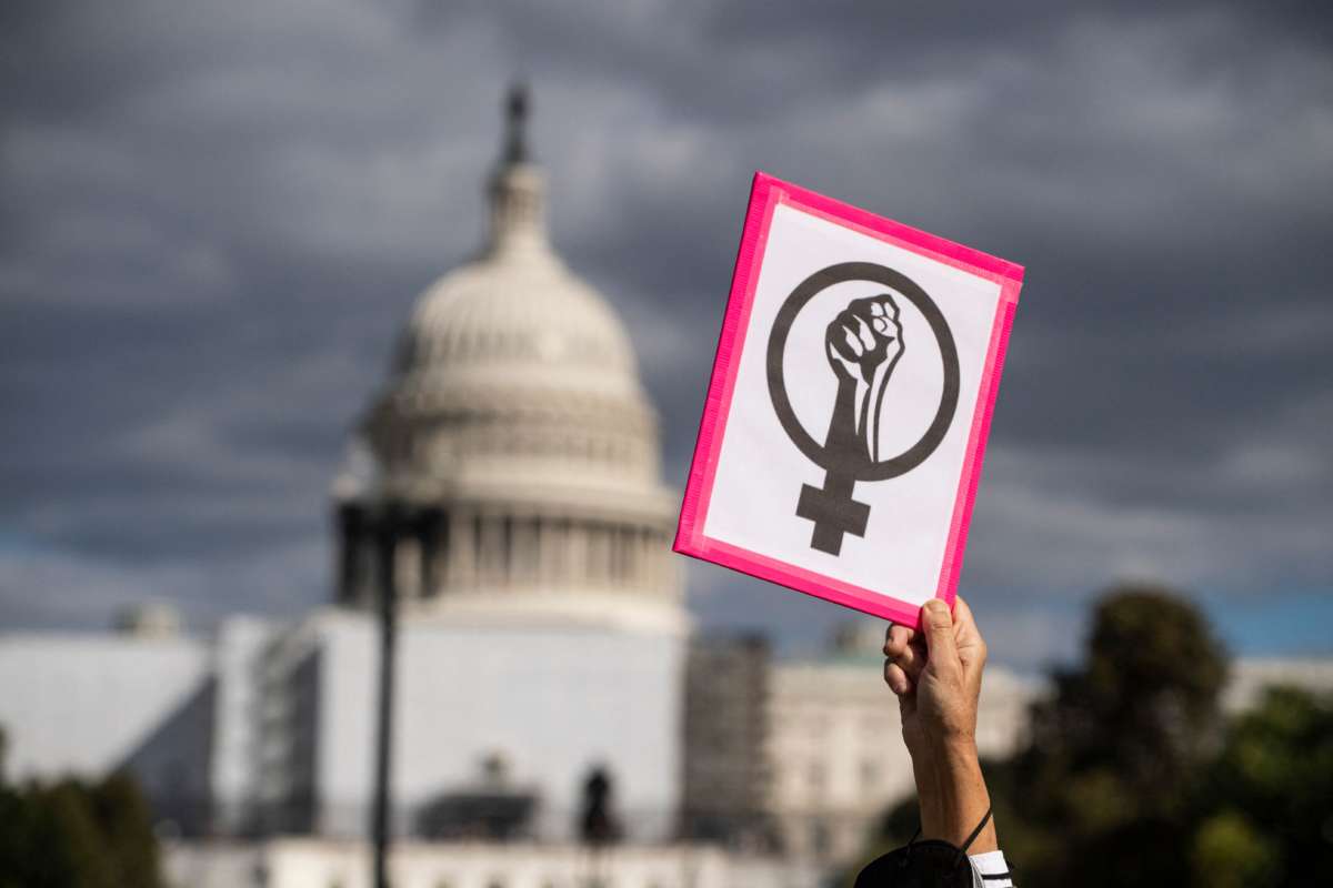 An abortion rights demonstrator holds a sign near the U.S. Capitol during the annual Women's March to support women's rights in Washington, D.C, October 8, 2022.