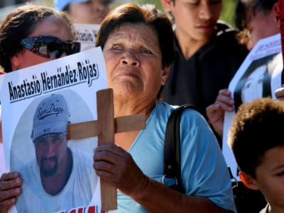 Maria de La Luz Rojas stands with a picture of her son Anastasio Hernández Rojas, who was killed by a Border Patrol agent, during a rally at the U.S.-Mexico border in San Ysidro, California on February 23, 2013.
