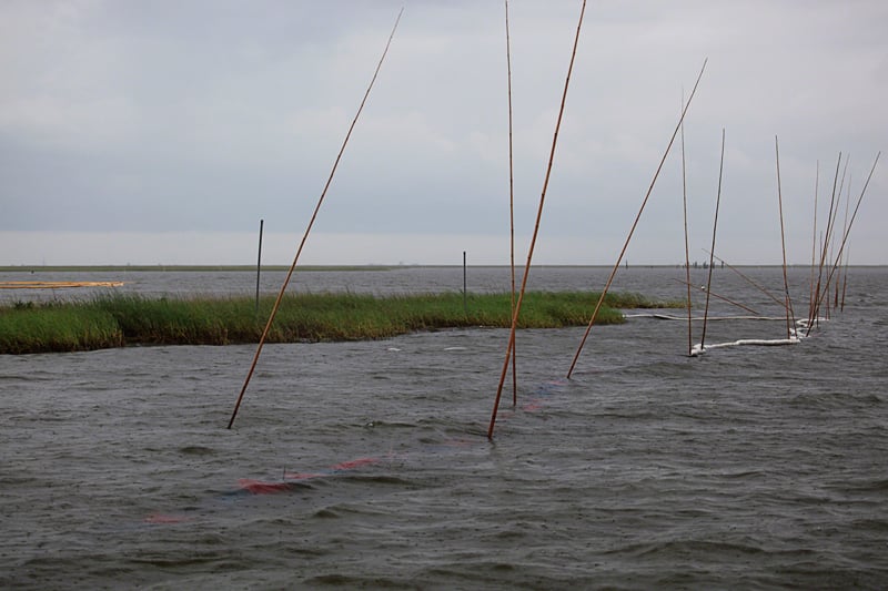Boom off its support in Louisiana wetlands. Photo by Erika Blumenfeld.