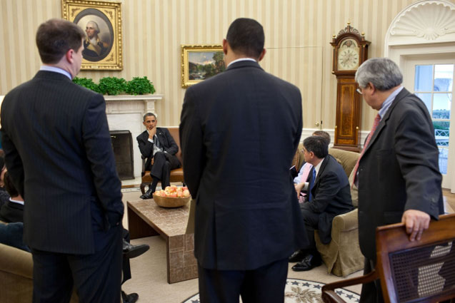 President Barack Obama consulting with advisors.