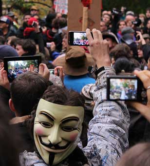 Occupy protesters, one with a Guy Fawkes mask