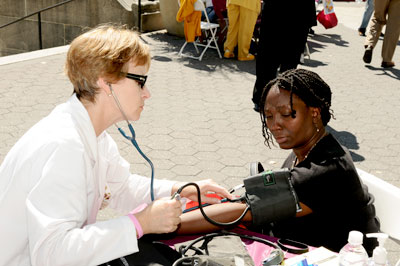 A woman has her blood pressure checked
