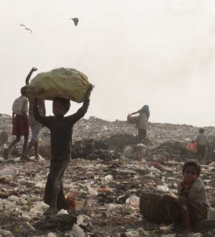 Picking through scraps in a Kolkata, India waste dump.