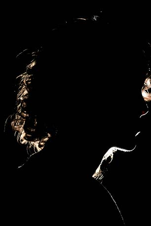 Profile of woman in dark