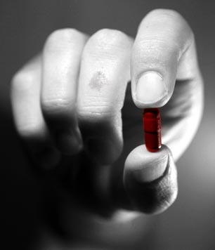 Red pill in hand