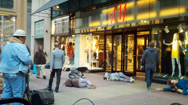 A group of Chicago artists feign illness at the city's flagship H&M location. (Photo: Anne Elizabeth Moore)