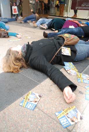 A still from the Brussels action, with leaflets. (Photo: Clean Clothes Campaign)