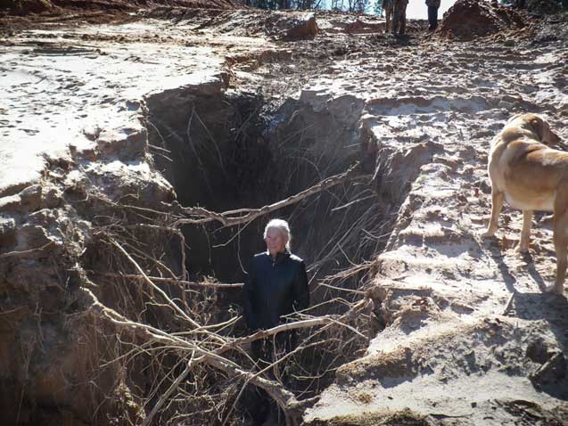 Photo of Eleanor Fairchild in a hole that opened up on her land due to erosion caused by the KXL pipeline installation. (Photo: ©Cathy DaSilva, January 16, 2013)