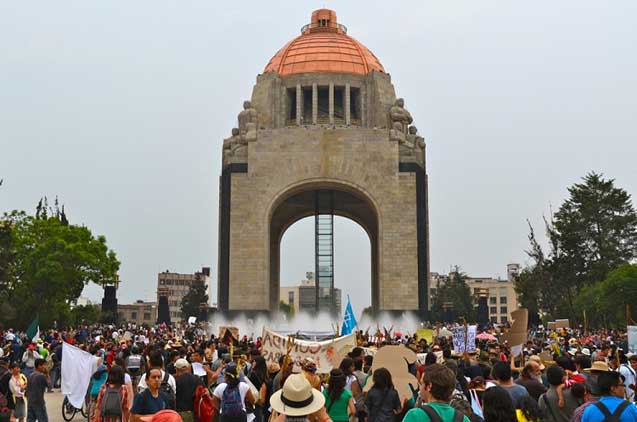 The thousands of protesters marched down principal avenues in Mexico City to arrive at The Monument of the Revolution.