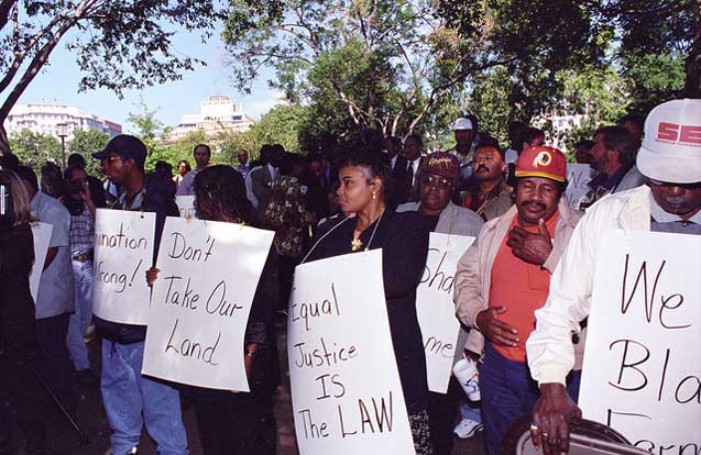 Black farmers protest at Lafayette Park across from the White House in Washington, D.C. on September 22, 1997. Protesters alleged the U.S. Department of Agriculture (USDA) denied black farmers equal access to farm loans and assistance based on their race. North Carolina farmer Timothy Pigford and 400 other black farmers filed the Pigford v. Glickman (Pigford I) class-action lawsuit against USDA in 1997. The USDA settled Pigford I in 1999.