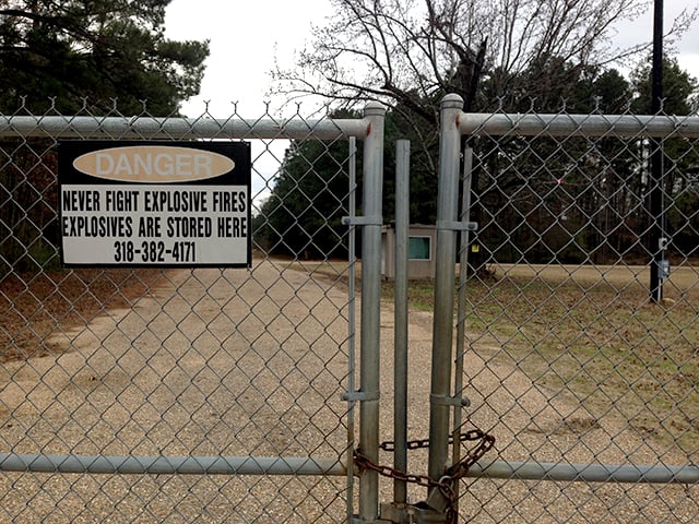 A locked gate and warning sign at the Camp Minden military facility near Minden, Louisiana. Fearing cancer-causing pollution, local residents are opposing an EPA plan to burn 15 million pounds of hazardous artillery munitions waste in open 