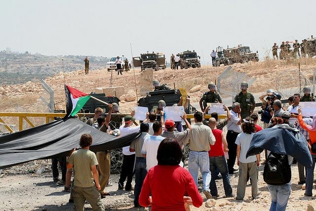 The people of Bil'in marched in silence to the Apartheid Wall with the support of Israelis and internationals during a July 21, 2006 demonstration.