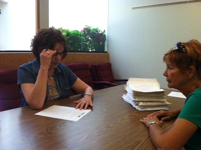 Merrily Mazza, while running for City Council, reviews petitions to place Lafayette's ban on oil and gas drilling with Lafayette City Clerk Susan Koster, 2013. (Photo: Cliff Willmeng and East Boulder County United)