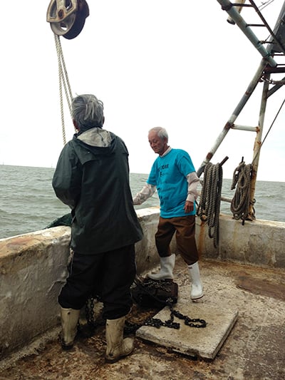 Bien Do and a fellow fisherman trawl for shrimp in Gulf waters. (Photo: Mike Ludvig)