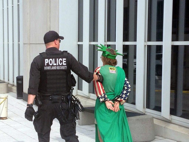 14 July, 2014: Police officer arrests anti-Cove Point demonstrator at a sit-in at the Federa Energy Regulatory Commission in Washington, D.C. (Photo: chesapeakeclimate)