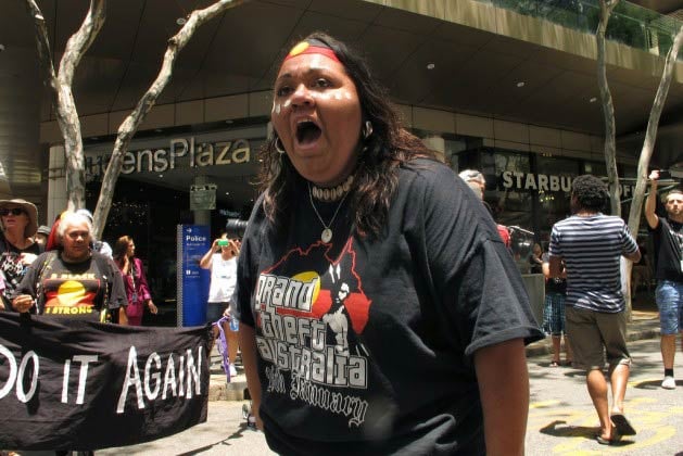 An Aboriginal activist shouts slogans during a march in Brisbane, Australia, to stop the cycle of 'stolen generations' of Aboriginal children. (Photo: Silvia Boarini/IPS)
