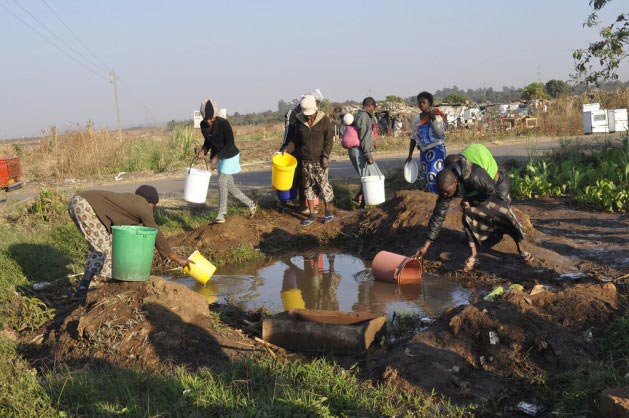 Whether they like it or not, many Africans faced with the possibility of having to access water through prepaid meters have resorted to unprotected and often unclean sources of water because they cannot afford to pay. (Photo: Jeffrey Moyo/IPS)