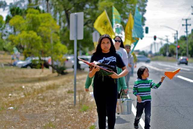 Thirteen-year old Cinnamon Perez, of Lakota heritage, led the prayer staff for part of the walk. “I went for the first walk and wanted to come back again,” she said. Cinnamon, who shared her love for the ocean and hoped that environmental health would be restored one day. (Photo: Rucha Chitnis)