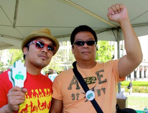 Armael Bulawin Malinis and Edgardo Pichay, male allies and community organizers at Migrante International, an advocacy group that defends the rights and welfare of overseas Filipino workers, raise their fists in solidarity with the rights of home care workers. (Photo: Rucha Chitnis)