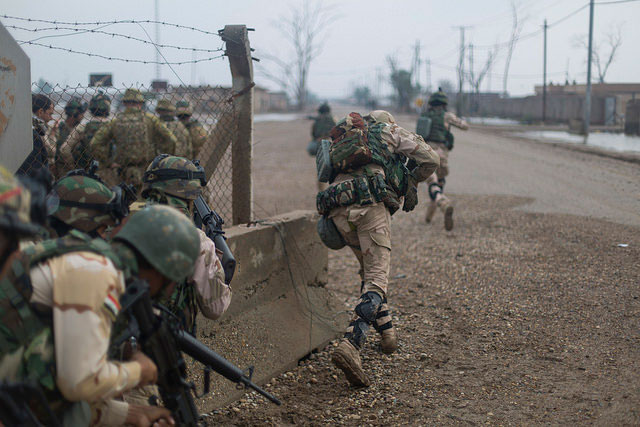 Iraqi soldiers assigned to 71st Iraqi Army Brigade move closer to an objective during a simulated exercise under fire at Camp Taji, Iraq, Nov. 18, 2015. This training is in support of Combined Joint Task Force &ndash; Operation Inherent Resolve, a coalition of 60-plus nations that have joined together against the Islamic State of Iraq and the Levant.