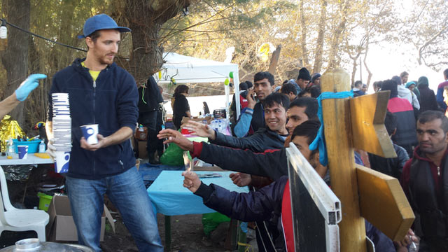 The soup of human kindness: freshly arrived refugees gather round volunteer food kitchens on the north of the Greek island of Lesbos. (Photo: Peter Bach)