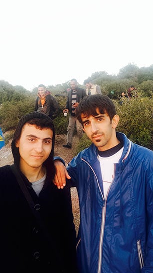 Two friendly young Syrian men near Oxy Transit Camp. On Lesbos, I believe we have been handed a clear opportunity to defeat the ideologues, the beheaders, the murderers, the torturers and tyrants, writes James Fennell. (Photo: Peter Bach)