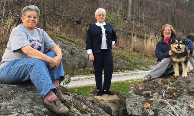 Sisters Kathy DiVaio (at left), Jan Barthel, and Diantha Daniels (with Lady Bear, one of the monastery dogs) at Mt. Tabor. (Photo by the author)