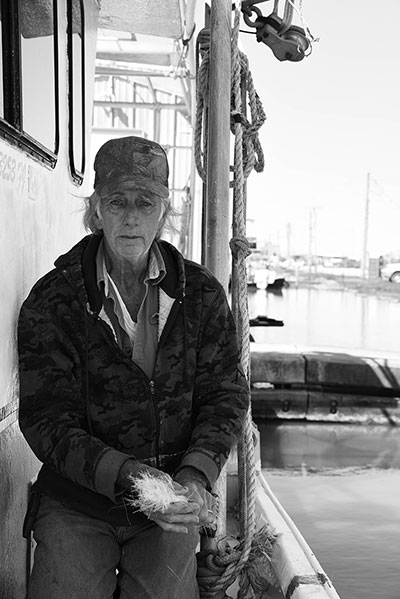 A Venice native makes repairs to his son's boat in preparation for shrimping season. (Photo: Michael Stein)